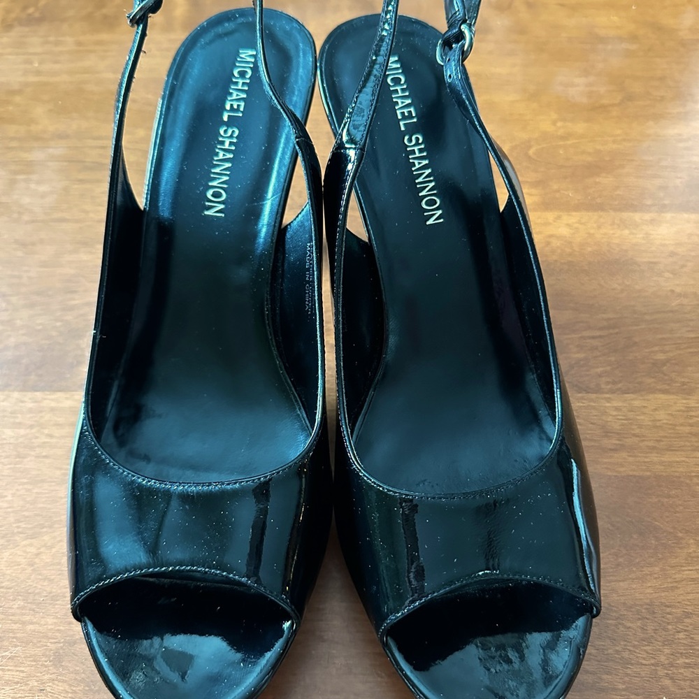 Patent Leather Black size 11 strapped heels.